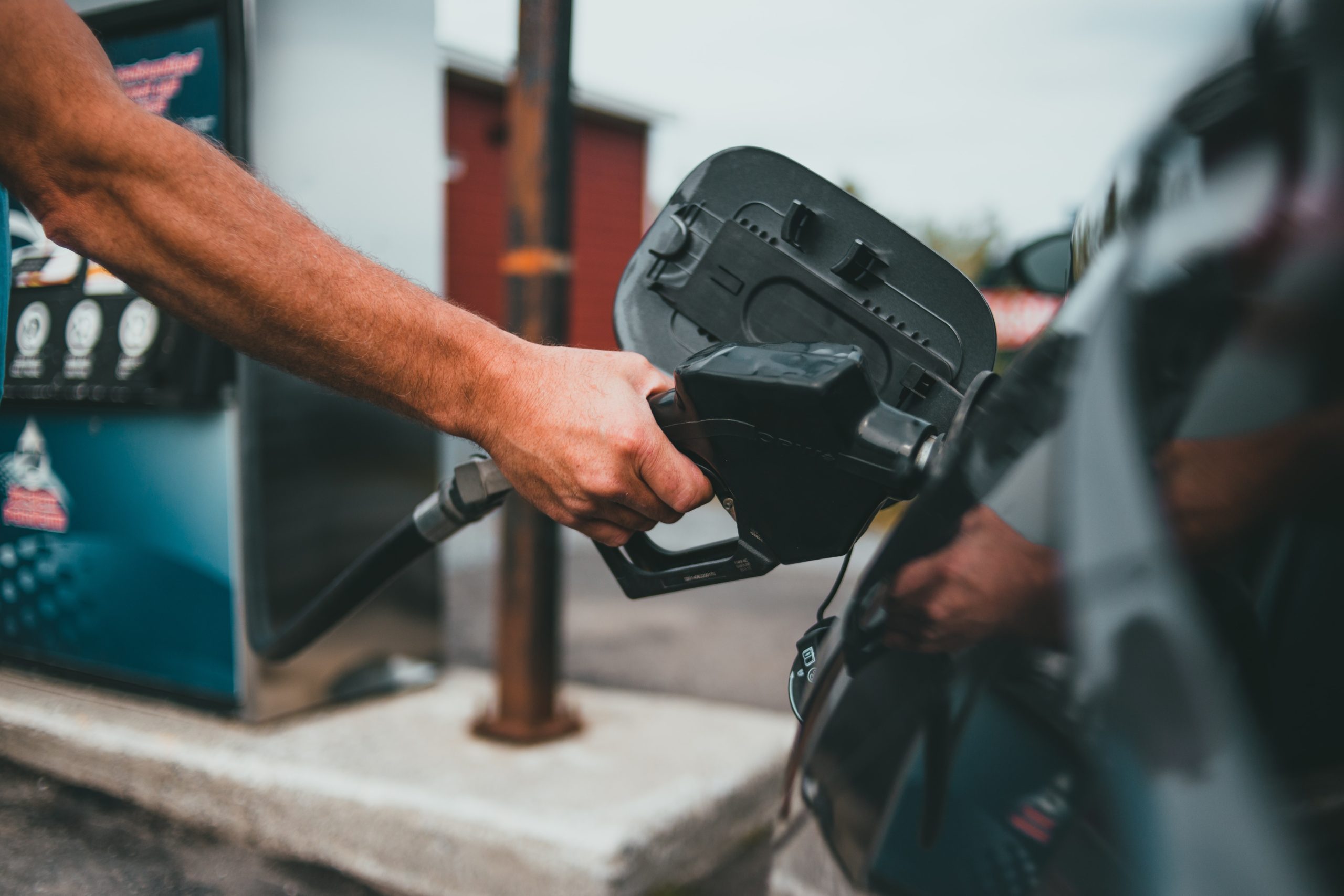 A man fills his car with gas